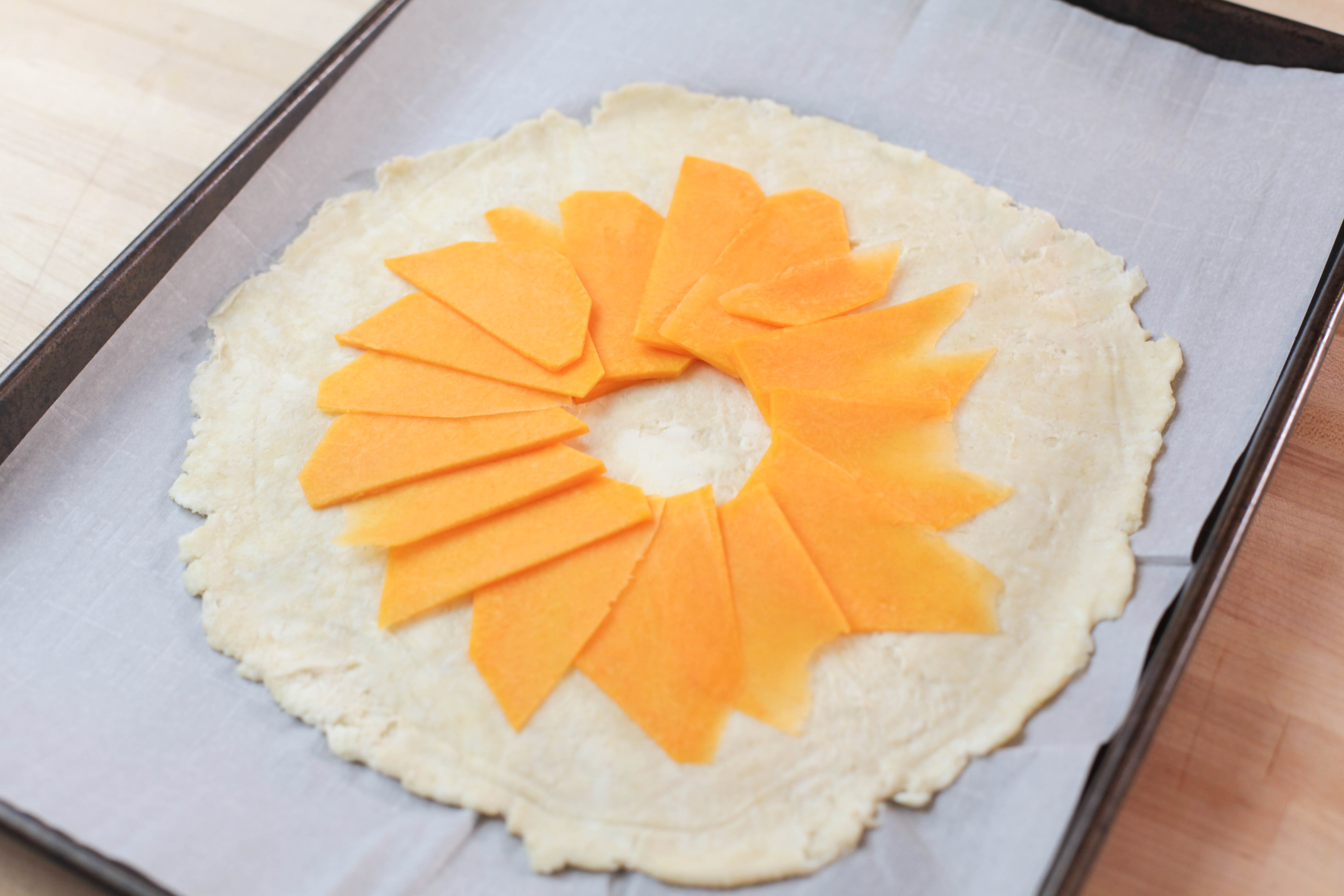 slices of butternut squash on galette dough
