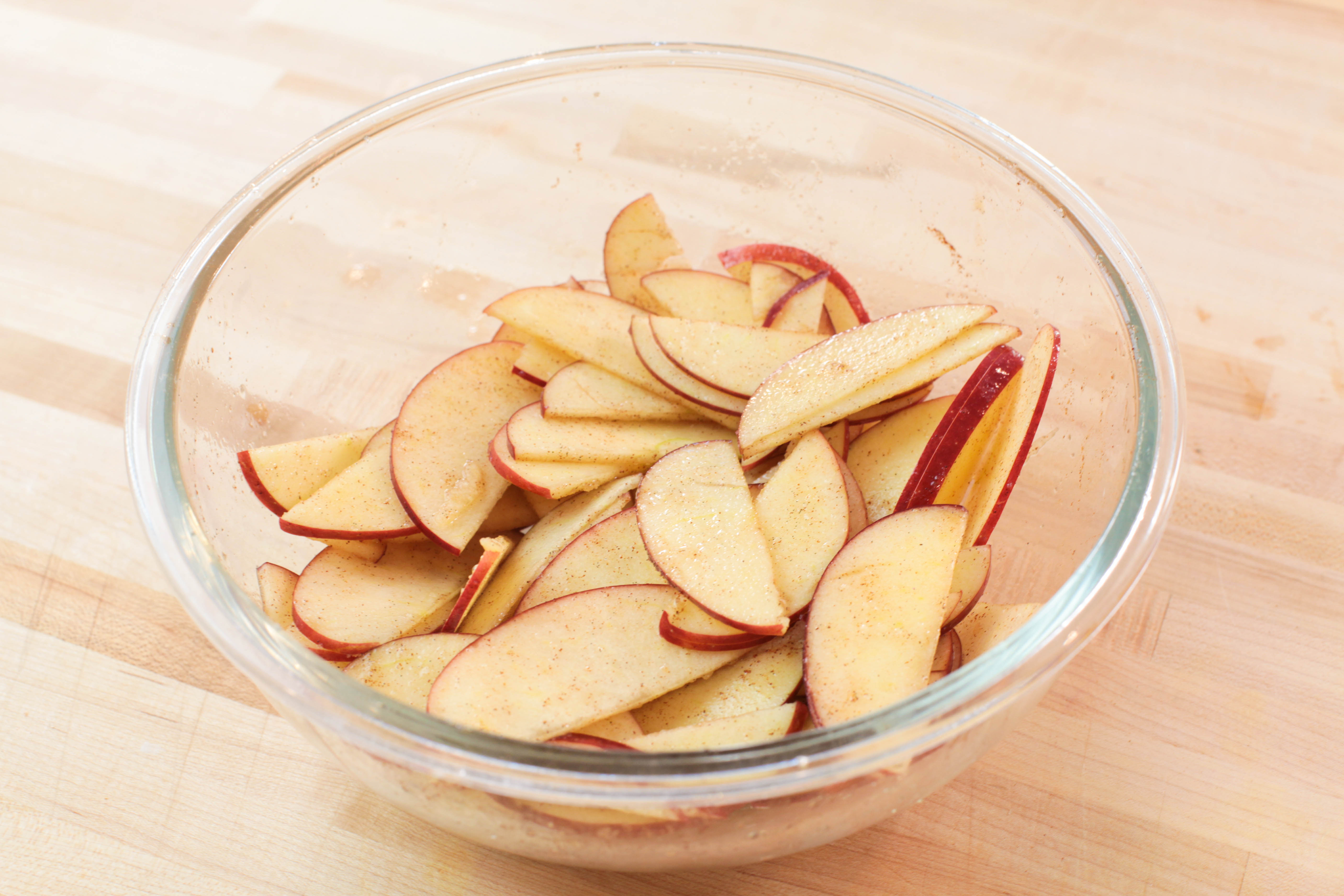 sliced apples coated in cinnamon, sugar, lemon juice, and vanilla paste